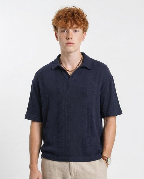 Man wearing a navy blue polo shirt on a white background