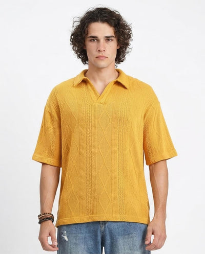 Man wearing a yellow knitted polo shirt on a white background