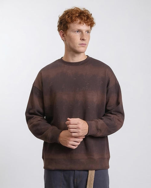Man wearing a brown sweatshirt against a white background