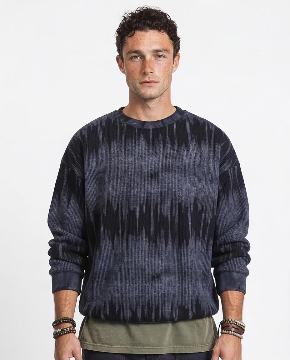 Man wearing a dark blue tie-dye sweater on a white background