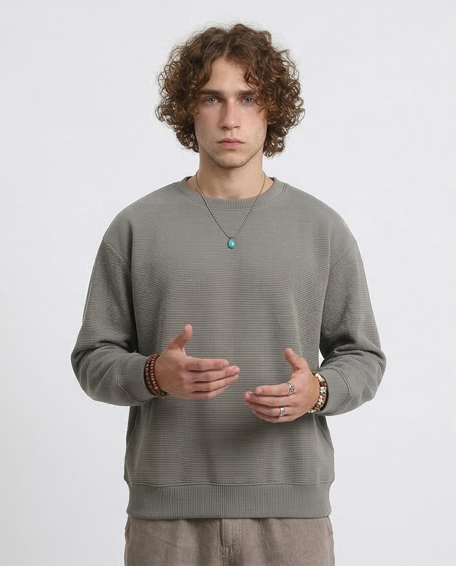 Man wearing a gray sweater on a white background