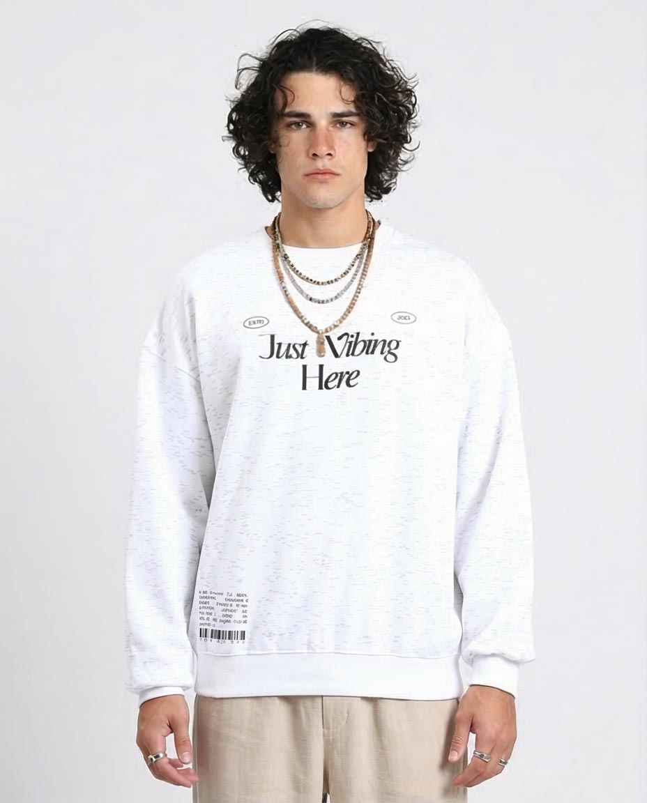 Person wearing a white sweatshirt with text on a plain background