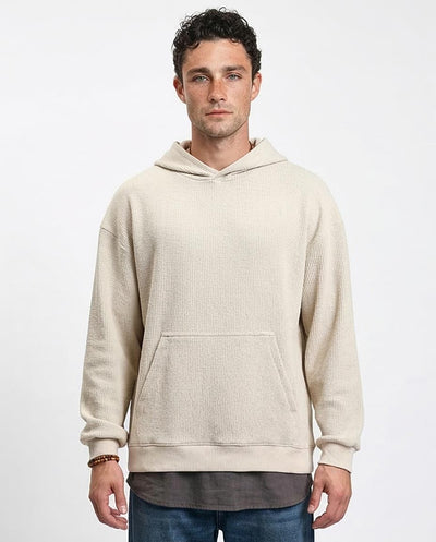 Man wearing a beige hoodie on a white background