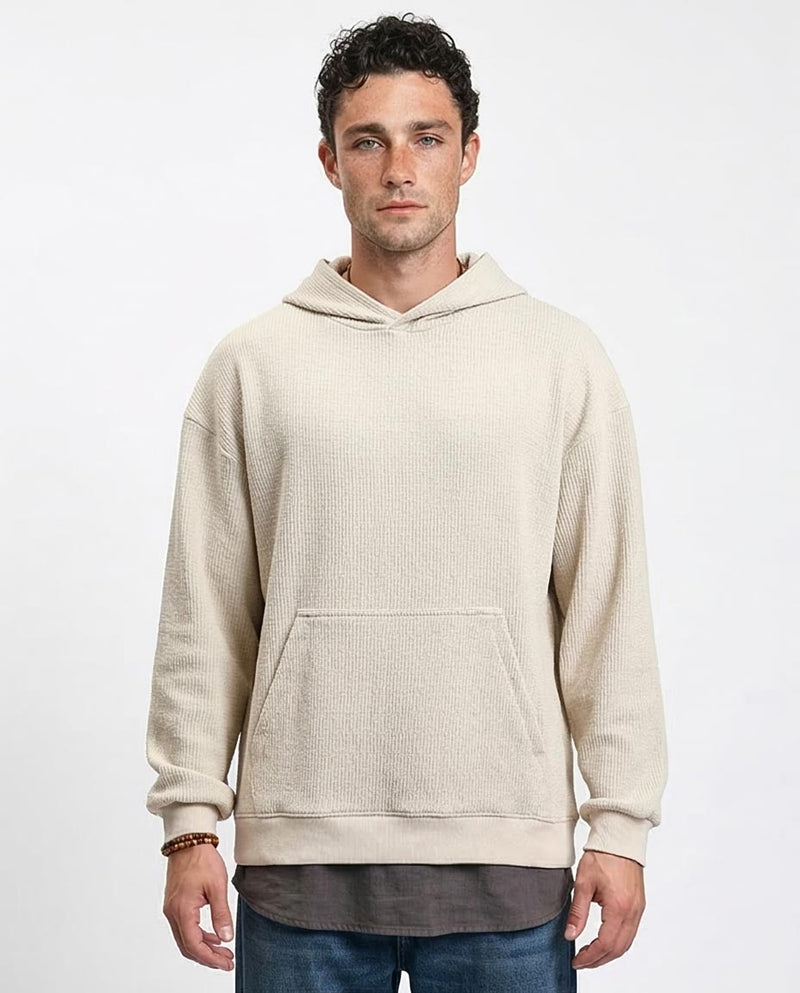 Man wearing a beige hoodie on a white background