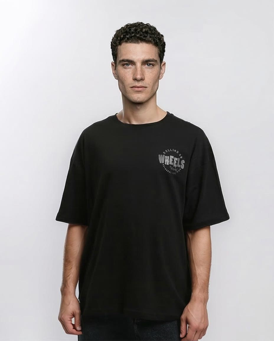 Man wearing a black t-shirt with a logo on a white background