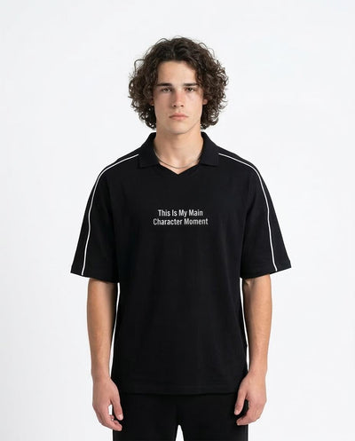 Man wearing a black polo shirt with text on a white background