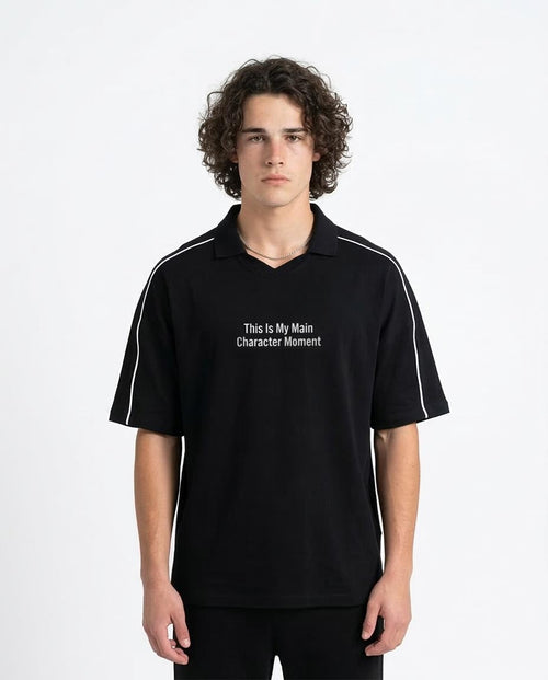 Man wearing a black polo shirt with text on a white background