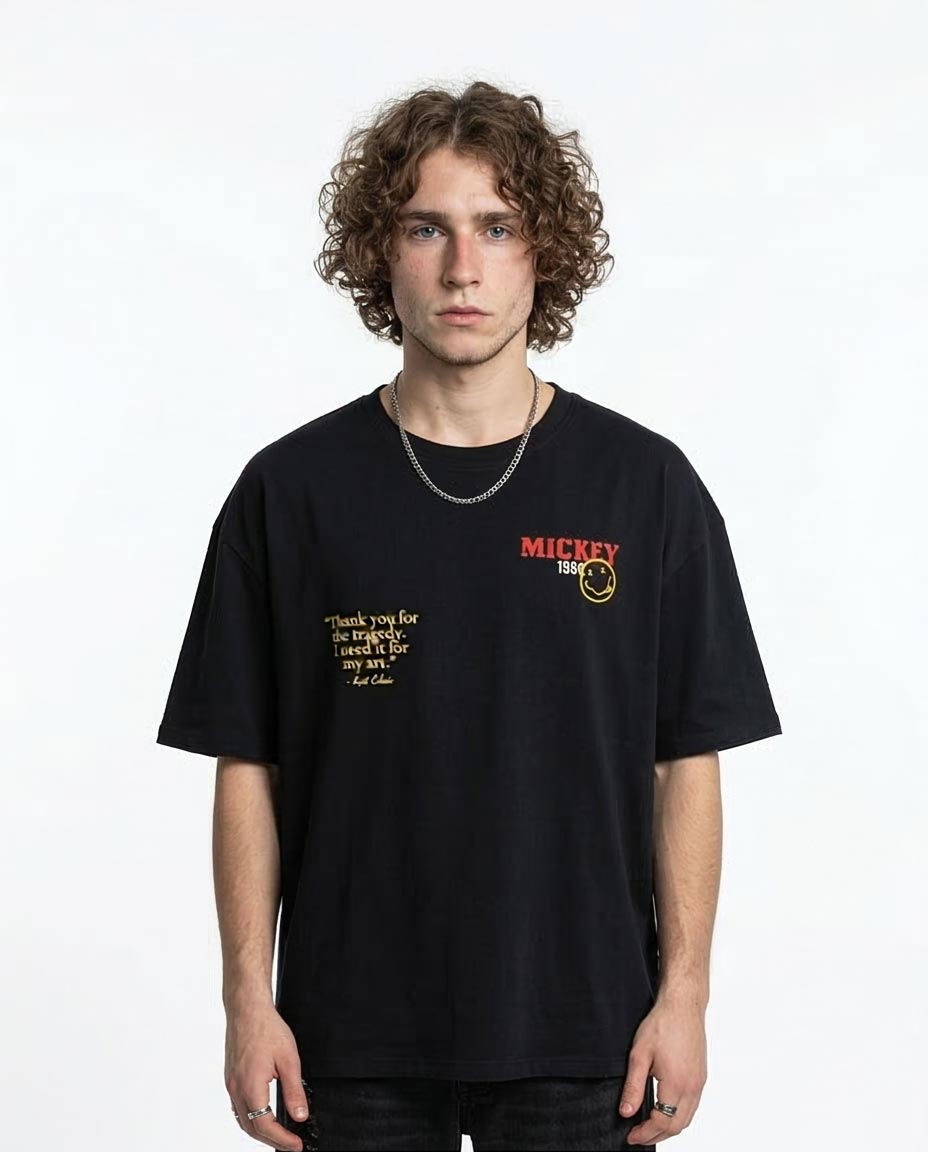 Person wearing a black t-shirt with text and logo on a white background