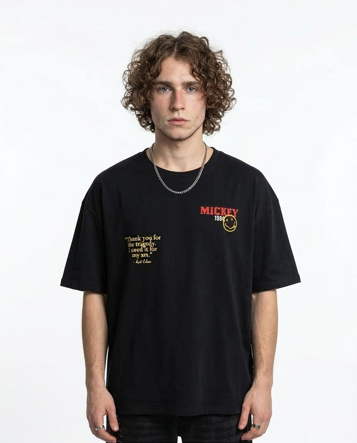 Person wearing a black t-shirt with text and logo on a white background