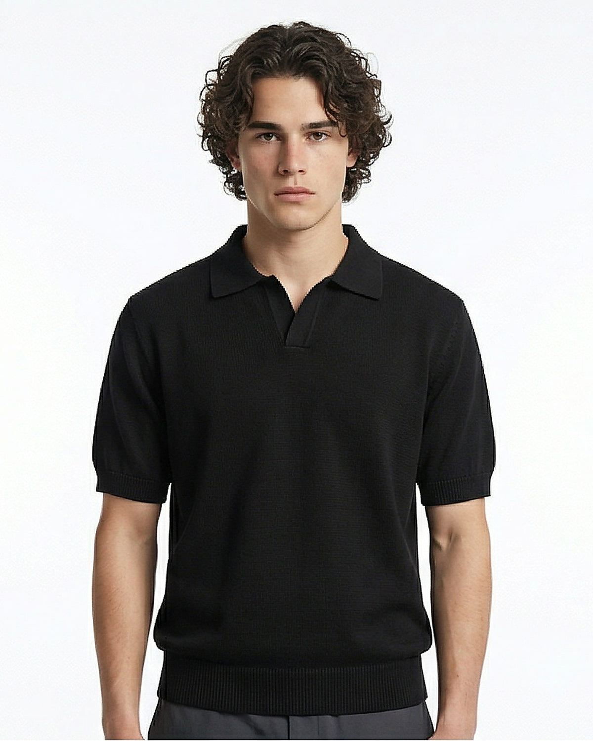 Man wearing a black polo shirt against a white background