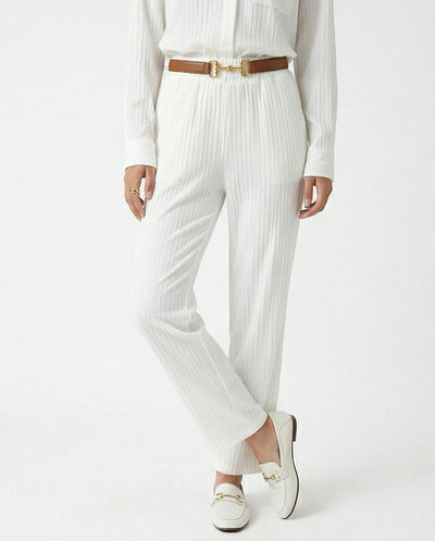 Person wearing a white outfit with a brown belt on a white background