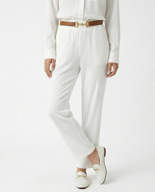 Person wearing a white outfit with a brown belt on a white background